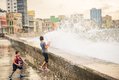 Waves-crash-over-the-Malecon,-kids-play-photo-by-Chad-Case.jpg