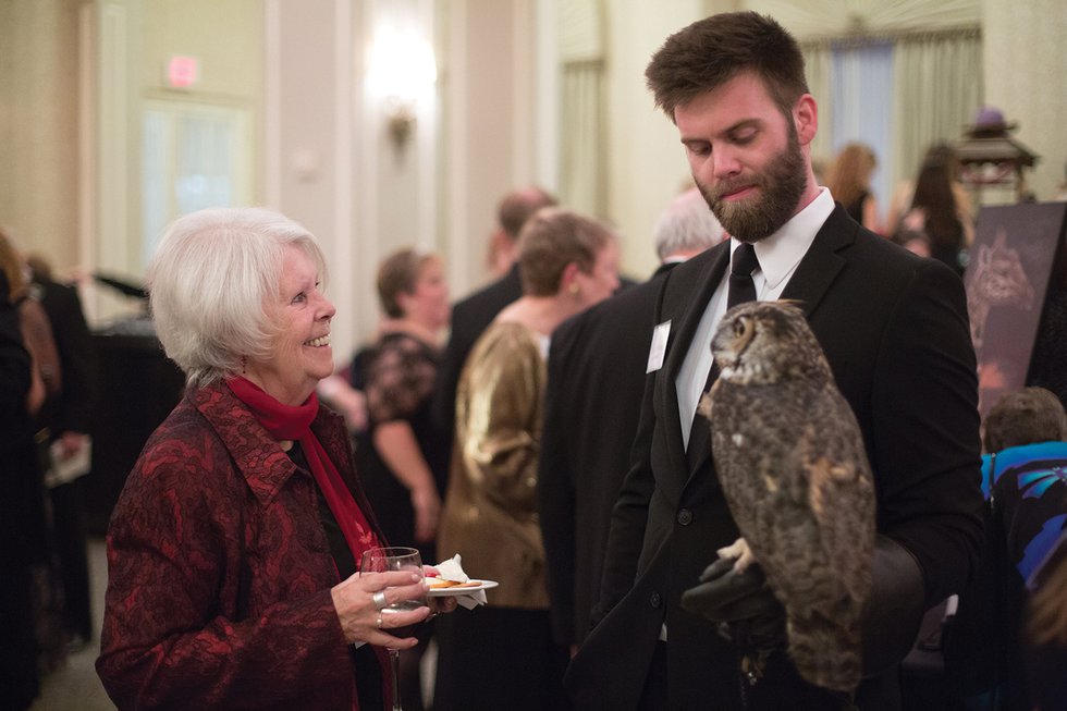 Outreach-Coordintaor-Alex-Wehrung-and-Great-Horned-Owl-Quinn-greet-guests-edit.jpg